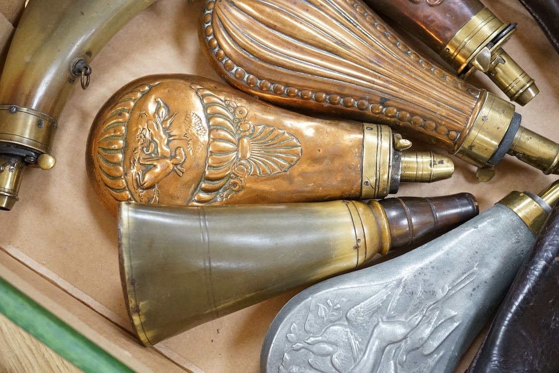 Nine powder flasks and shot flasks, all 19th century, comprising of two horn flasks, one flattened with brass mounts, three shot bags with sprung brass chargers, three copper gun flasks and another of zinc